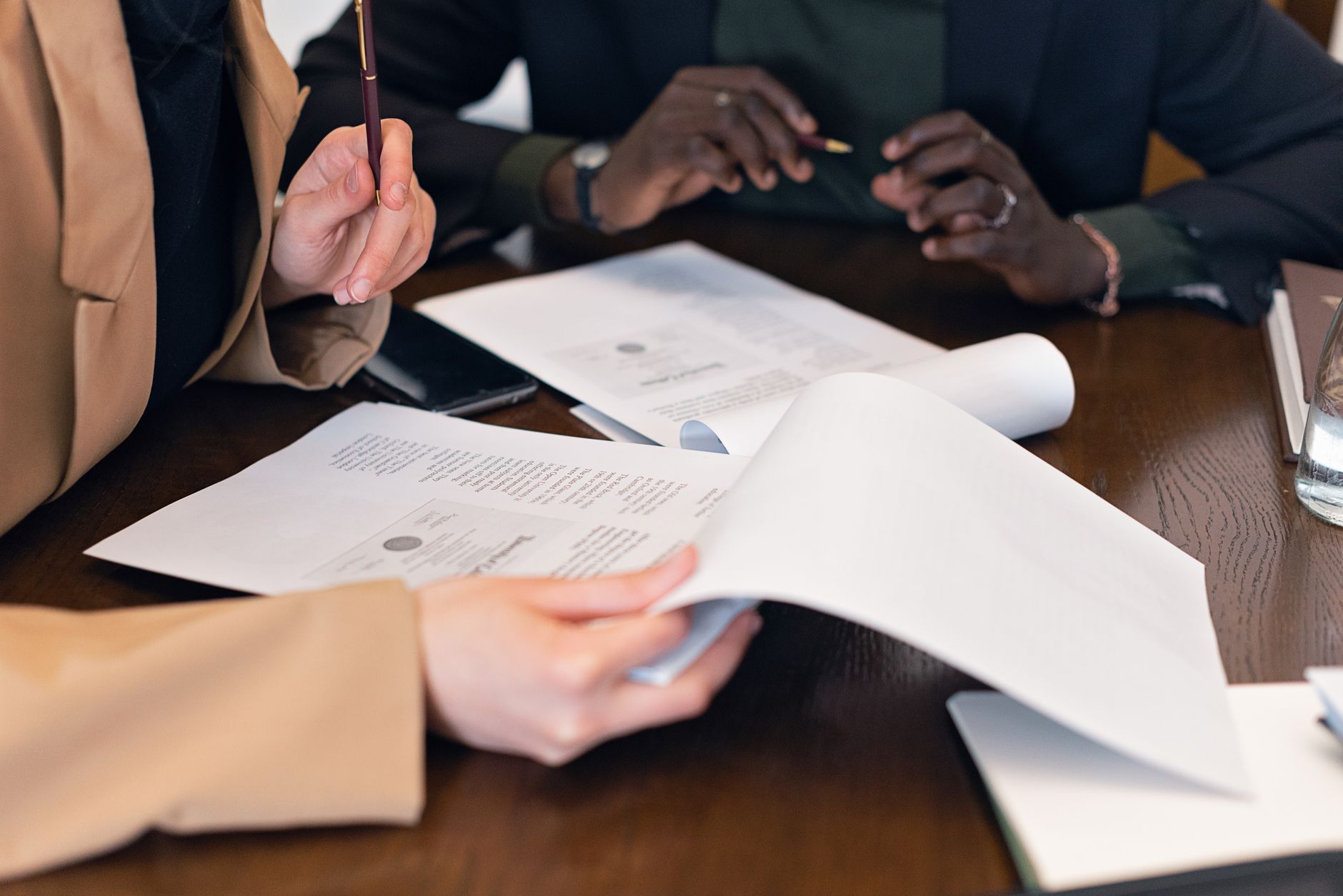 a close up shot of people reviewing documents